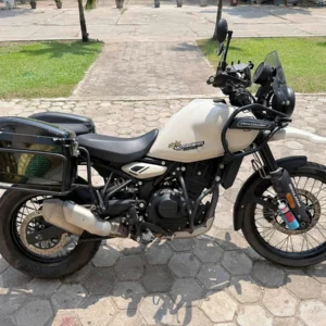 royal enfield himalayan 450cc adventure bike with side panniers for rent in laos with a side view